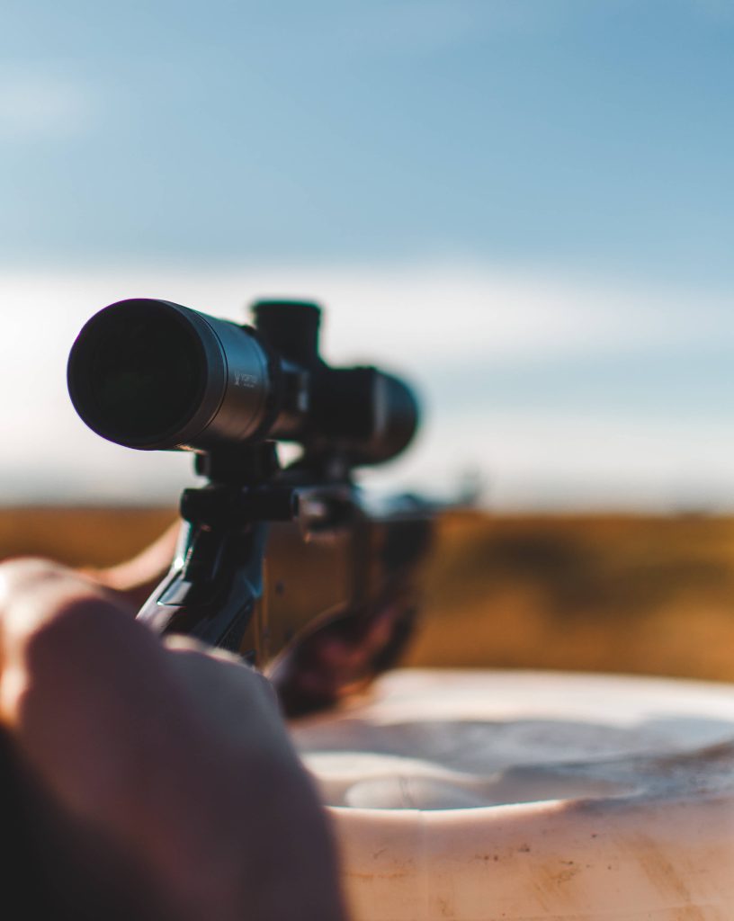 First-person view rifle with Vortex scope in golden outdoor field high-resolution gun wallpaper