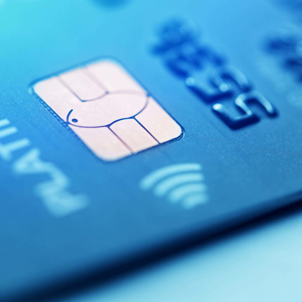 Close-up of credit card chip with metallic textures and blue lighting highlighting digital security Wallpaper