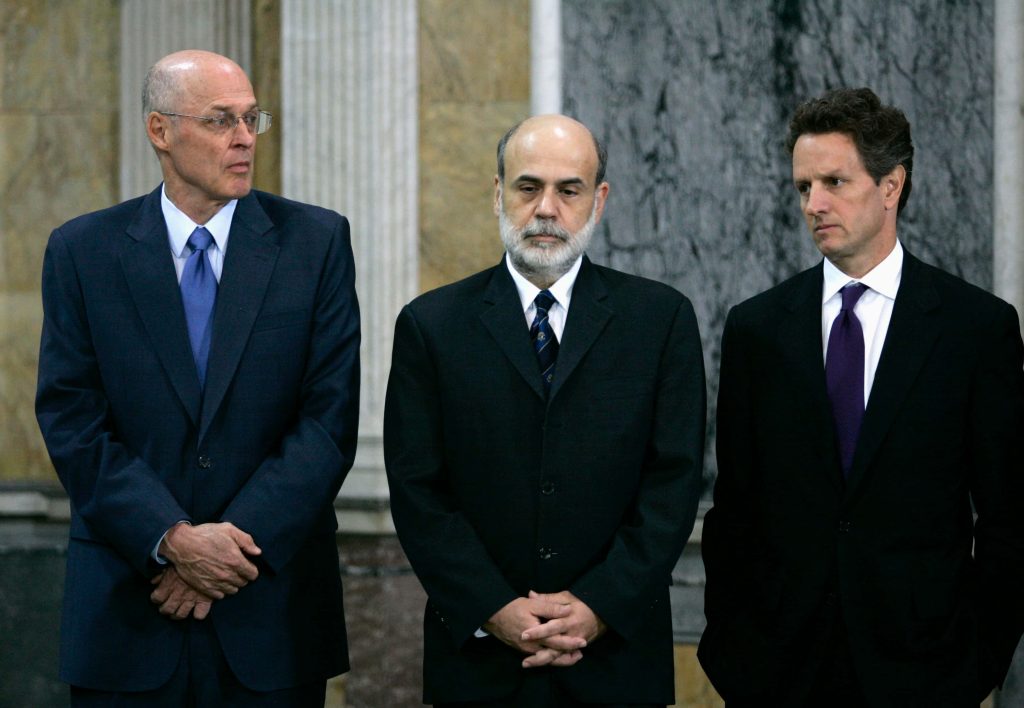 U.S. financial leaders Paulson Bernanke Geithner in suits by marble pillars 2008 crisis backdrop Wallpaper