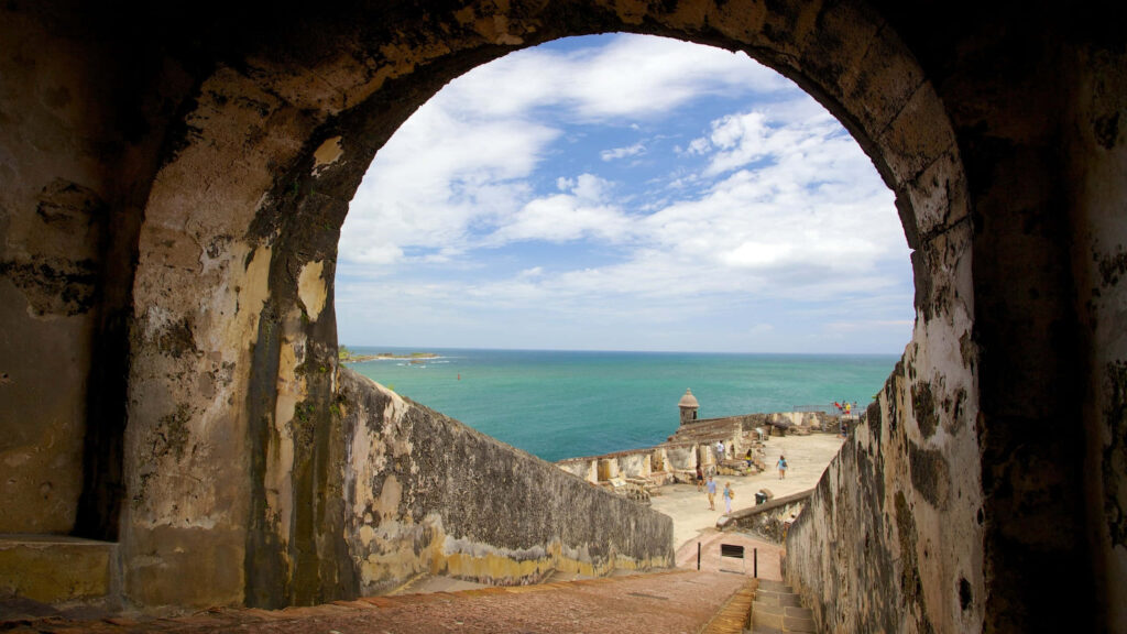 Historic Castillo San Felipe del Morro archway overlooking turquoise sea and clear blue sky wallpaper