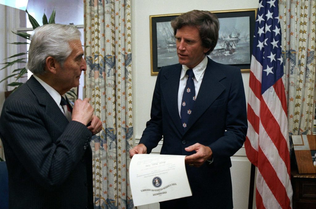 Historic image of Senator Gary Hart handing Presidential Seal document to Navy Secretary Hidalgo Wallpaper