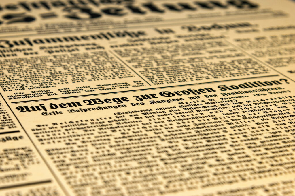 Vintage German newspaper wallpaper close-up Große Koalition 20th century sepia texture background