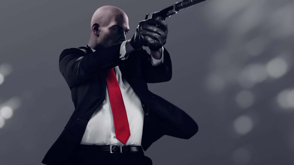 Agent 47 from Hitman 3 in black suit aiming silenced handgun minimal grey background wallpaper