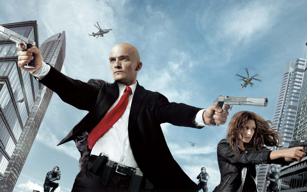 Hitman Agent 47 wallpaper Rupert Friend Hannah Ware action urban standoff dual pistols skyscrapers helicopter