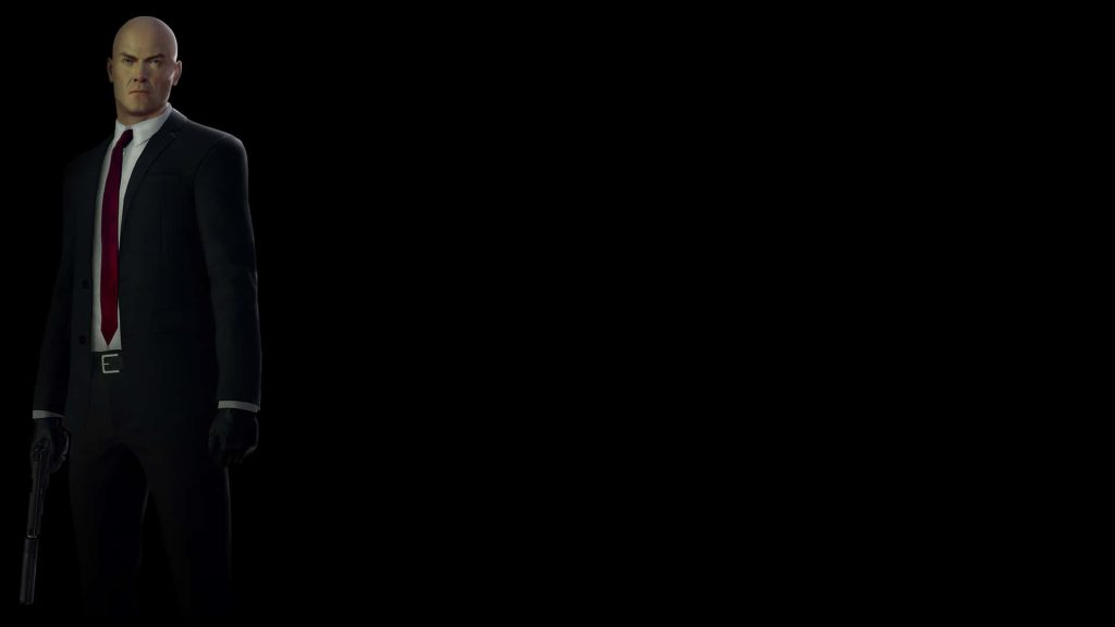 Agent 47 Hitman wallpaper CGI in black suit red tie holding silenced pistol on black background