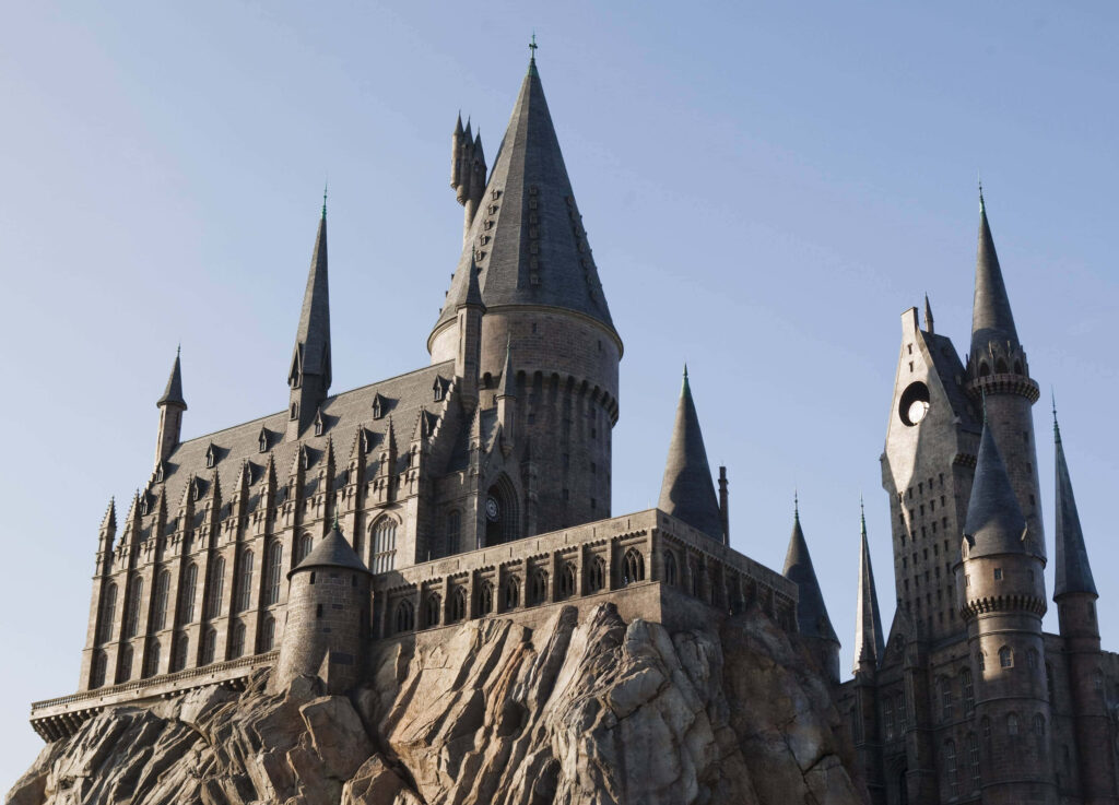 Hogwarts Castle wallpaper in grey tones showing detailed spires and stone architecture background