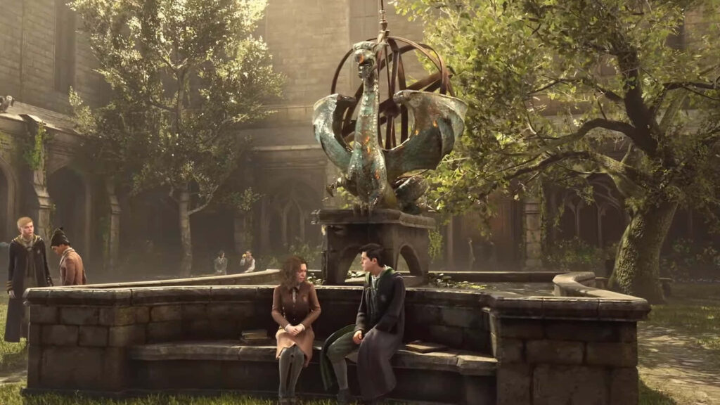 Two Hogwarts students talk on a stone bench by an ornate fountain in sunlit courtyard greenery Wallpaper