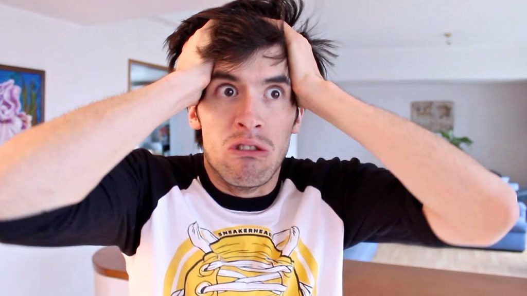 Germán Garmendia shocked expression pulling hair wearing SNEAKERHEAD tee high-res wallpaper