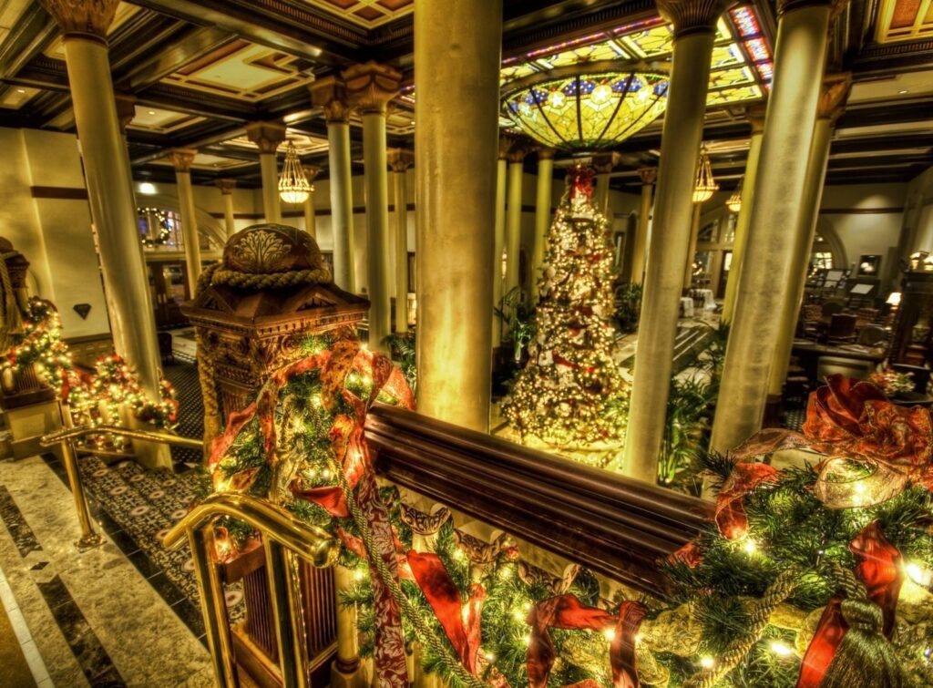 Festive Holiday Grand Hall: Christmas Tree & Elegant Decor Wallpaper