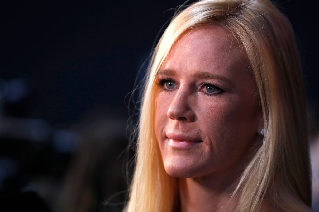 Close-up portrait of UFC fighter Holly Holm with blonde hair and focused intense gaze wallpaper