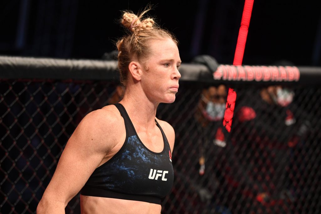 Holly Holm UFC Octagon intense MMA fight focused expression professional arena lighting Wallpaper