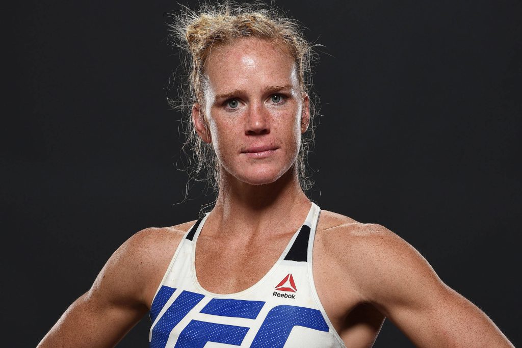 MMA champion Holly Holm in UFC Reebok gear focused intense portrait studio wallpaper