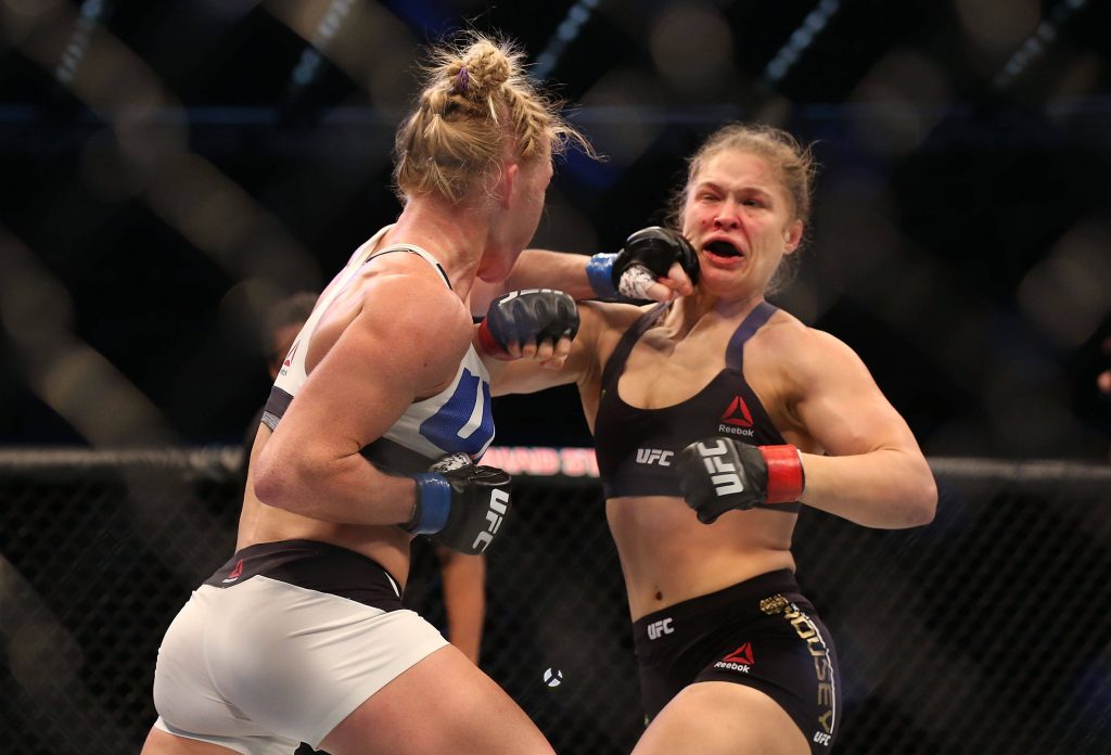 Holly Holm strikes Ronda Rousey UFC 193 Octagon intense MMA action wallpaper background