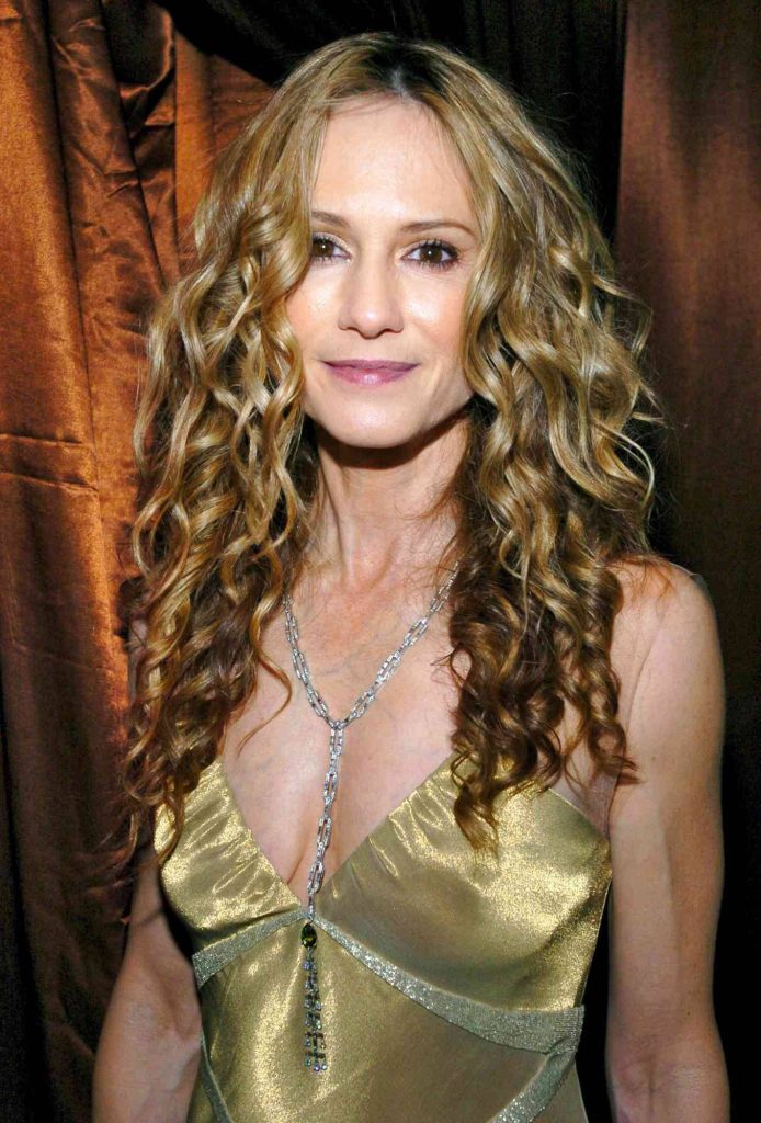 Holly Hunter radiant in metallic gold dress and silver necklace at Golden Globe After Party portrait Wallpaper