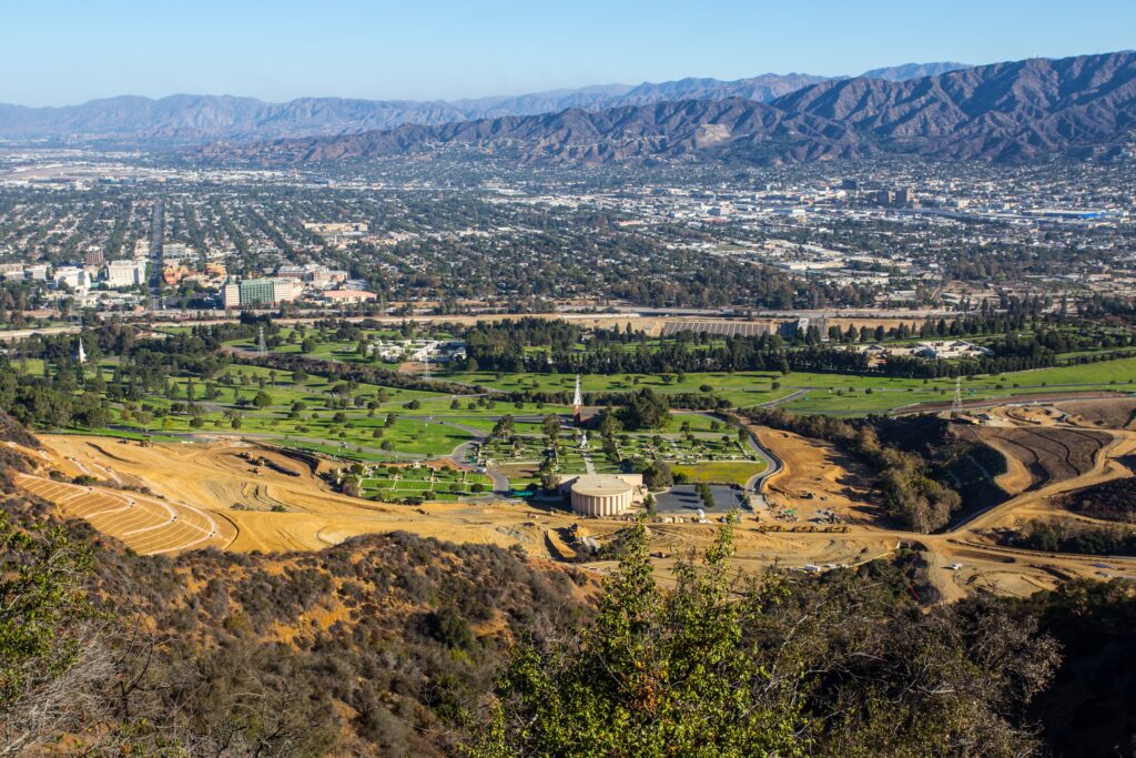 Panoramic Hollywood view from Griffith Park with green golf courses mountains and cityscape Wallpaper