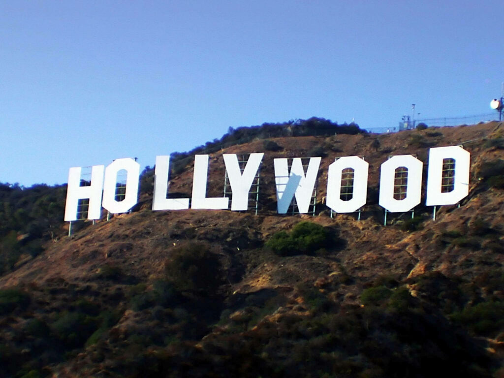 Hollywood Sign Wallpaper: Iconic Green Hillside Scene with Daylight Shadows