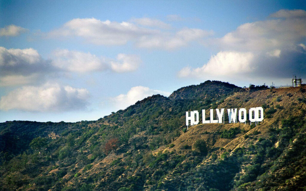 Hollywood Sign Scenic Wallpaper: Lush Green Peak & Soft Cloud Sky