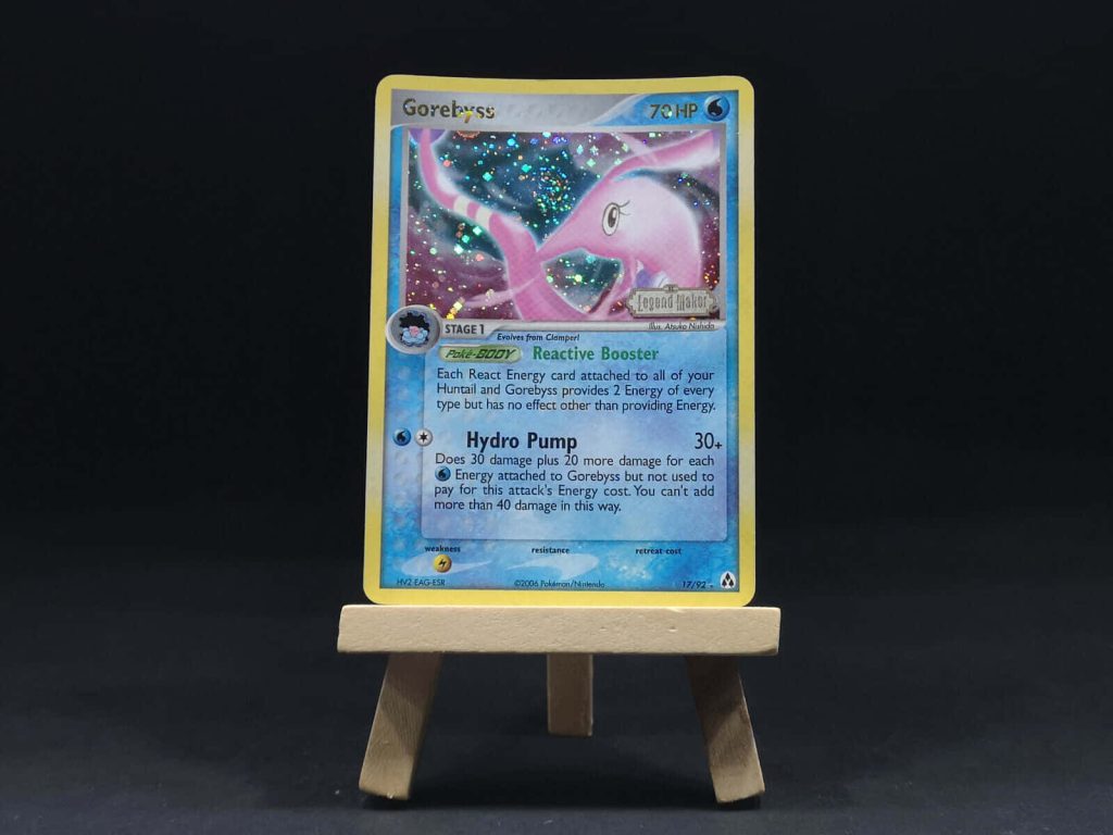Holographic Gorebyss Pokémon card on wooden easel with black background collectible wallpaper