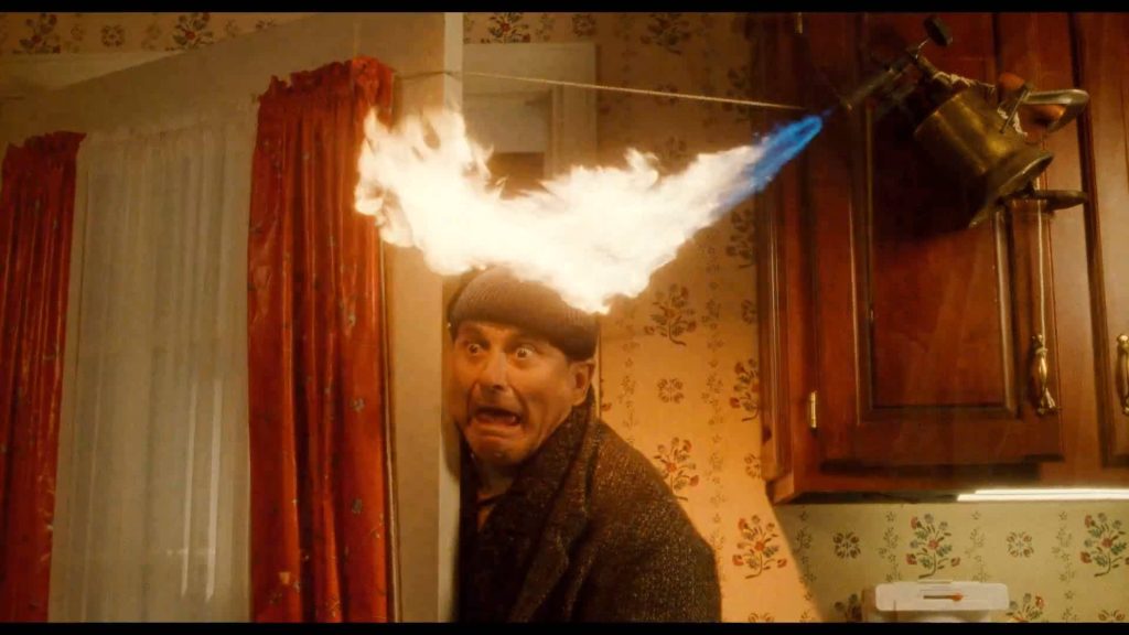 Home Alone Joe Pesci as Harry shocked by swinging blowtorch kitchen trap wallpaper background