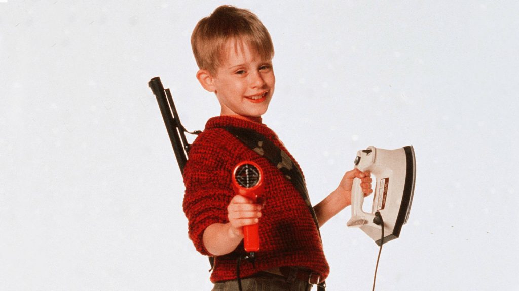 Home Alone wallpaper Macaulay Culkin as Kevin McCallister with red sweater and holiday props