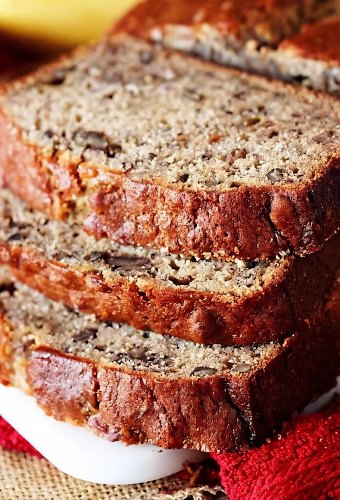 Close-up of moist homemade buttermilk banana bread with walnuts and crumb topping in natural light Wallpaper