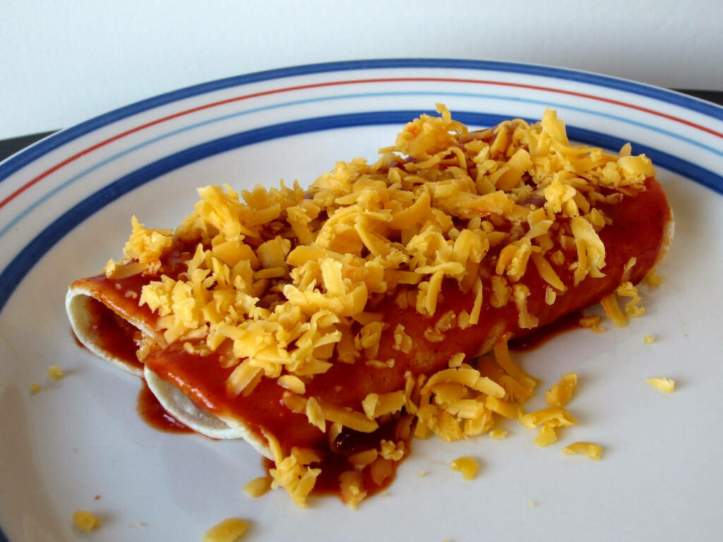 Delicious Homemade Enchiladas with Cheddar Cheese & Red Sauce Wallpaper