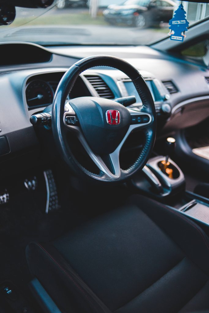 Honda cockpit wallpaper with red emblem steering wheel manual gear shifter metallic pedals