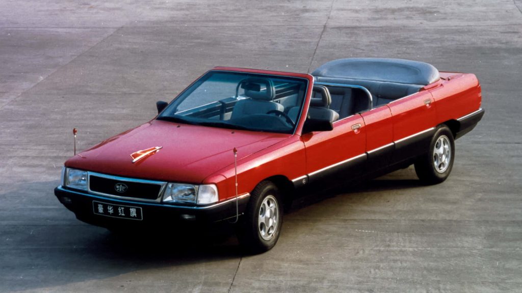 Red and black Hongqi parade car luxury convertible on concrete background wallpaper