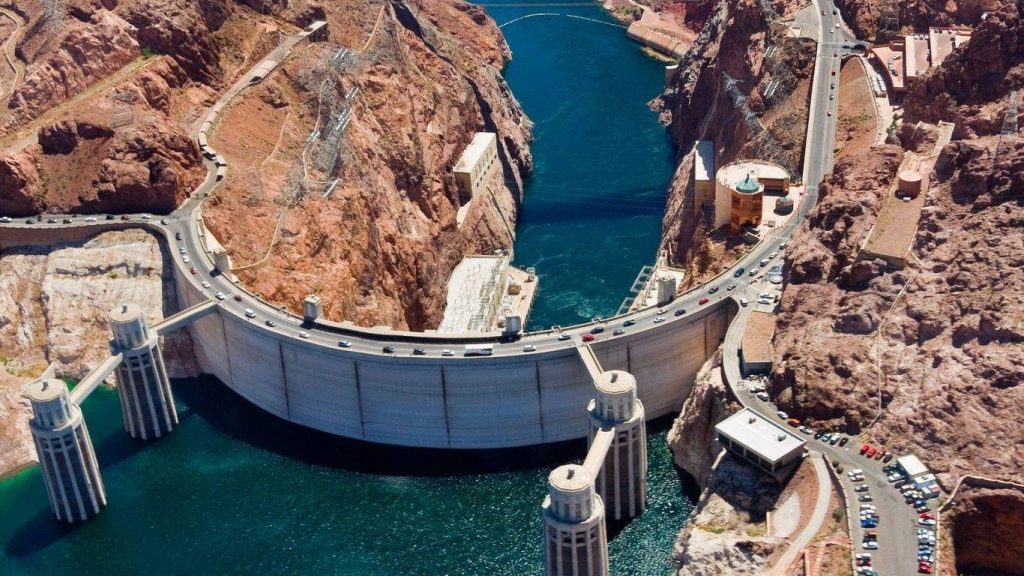 Aerial view of Hoover Dam over Colorado River between Arizona and Nevada with desert canyon walls Wallpaper