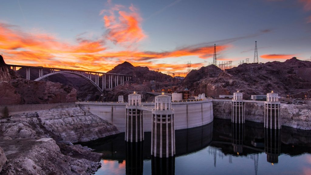 Hoover Dam at sunset with intake towers and Mike O'Callaghan Pat Tillman Bridge over canyon Wallpaper