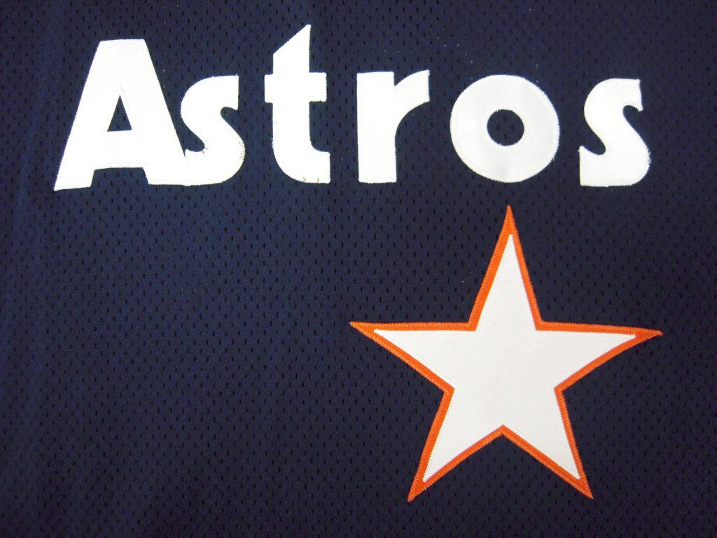 Houston Astros jersey close-up with white lettering and star logo on navy mesh fabric wallpaper