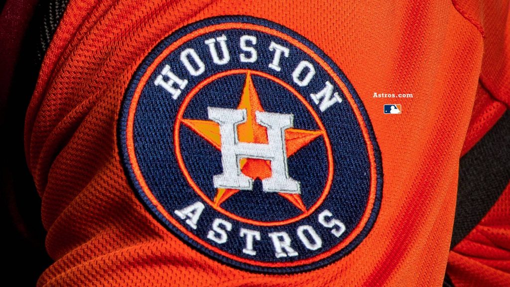 Houston Astros embroidered patch logo on textured orange jersey close-up wallpaper background