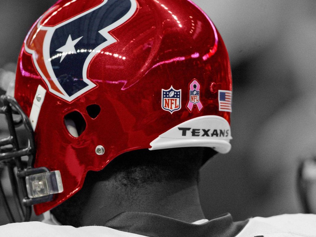 Close-up Houston Texans helmet with NFL logo and pink ribbon on grayscale intense background Wallpaper
