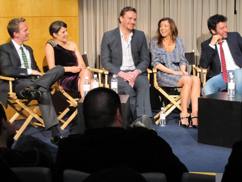 How I Met Your Mother cast panel discussion with Neil Patrick Harris and co stars on stage wallpaper