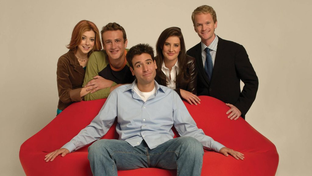 How I Met Your Mother cast on red couch iconic sitcom wallpaper nostalgic studio portrait