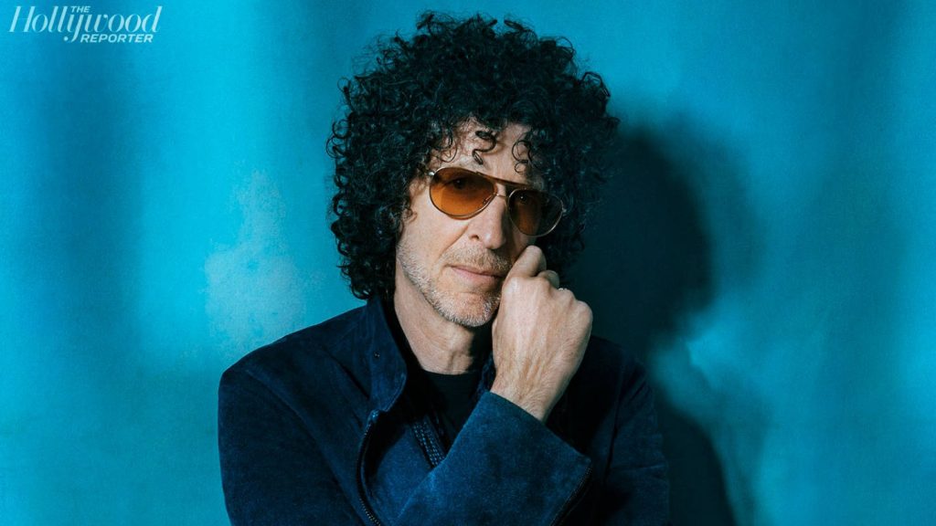 Howard Stern studio portrait with tinted sunglasses vibrant teal background professional look wallpaper