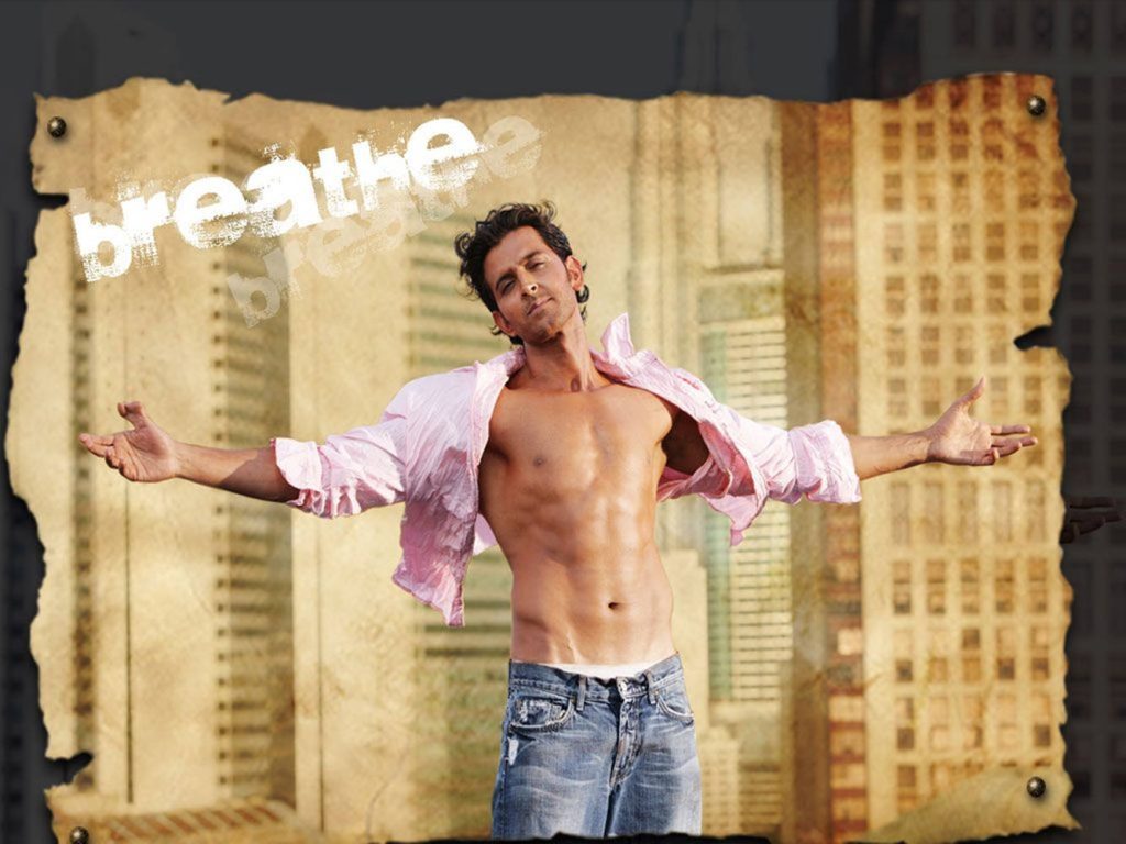 Hrithik Roshan wallpaper posing open pink shirt blue jeans city background breathe text frame