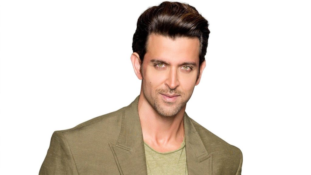 Portrait of Hrithik Roshan in olive green suit jacket on white background desktop wallpaper