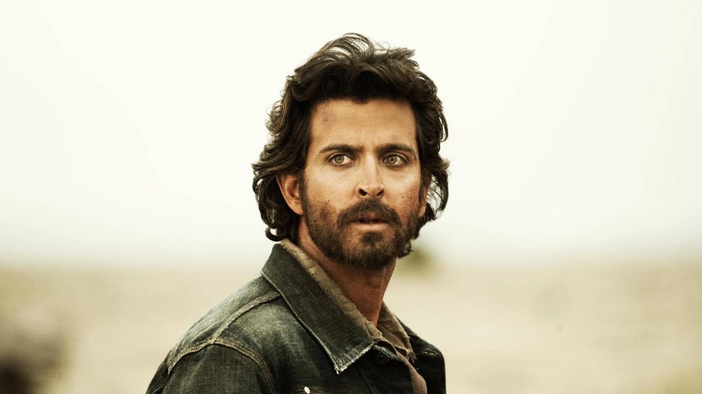 Hrithik Roshan cinematic portrait rugged look messy hair dark denim jacket bright background Wallpaper