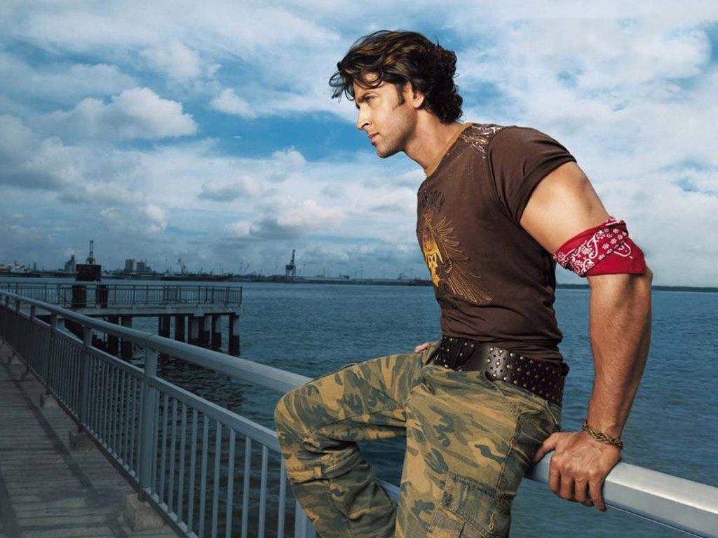 Hrithik Roshan rugged casual look brown tee camo pants red bandana by industrial waterfront Wallpaper