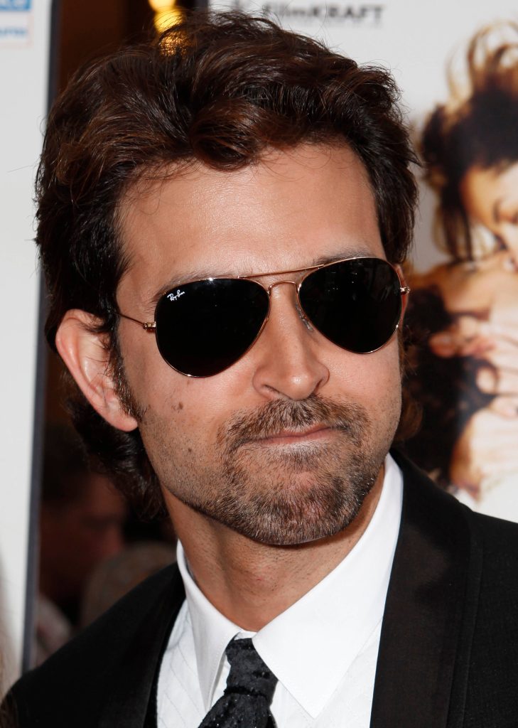 High-definition portrait of Hrithik Roshan in black suit white shirt and Ray-Ban aviator sunglasses Wallpaper