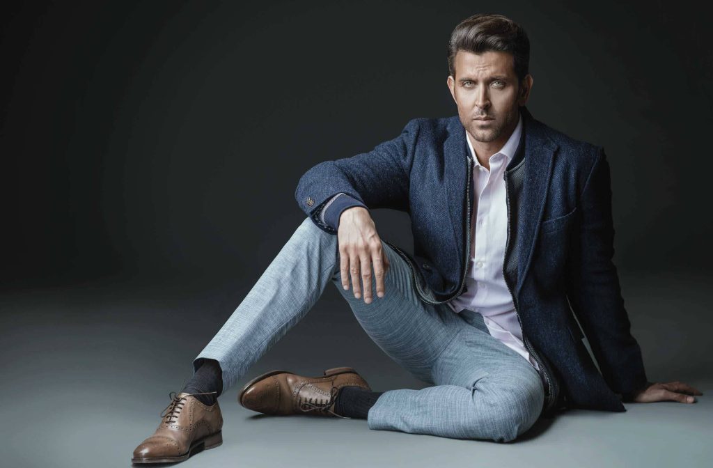 Hrithik Roshan in navy blazer white shirt grey trousers confident pose studio portrait wallpaper