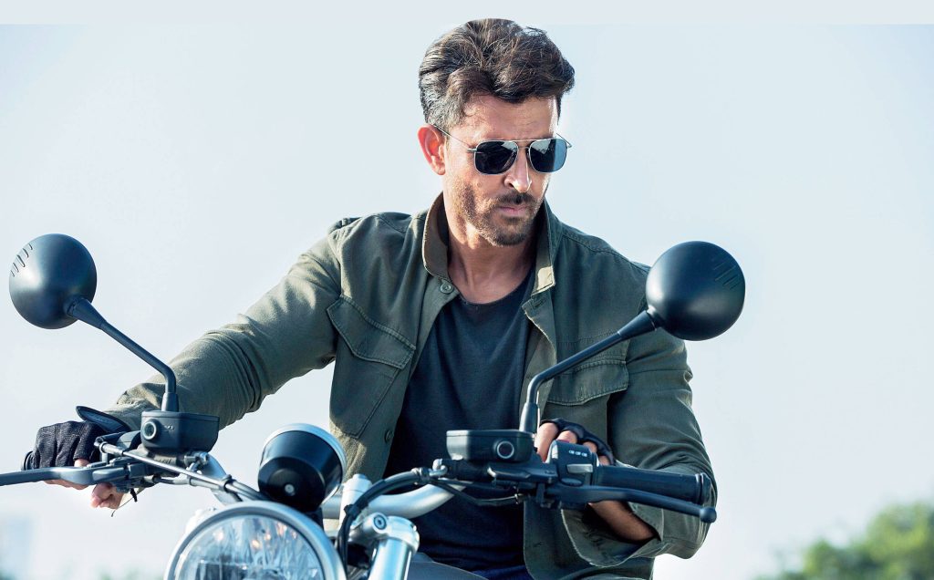 Hrithik Roshan action hero riding motorcycle in olive green jacket sunglasses War film wallpaper