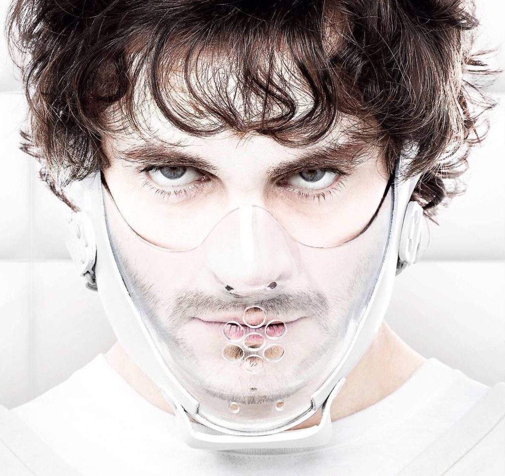 Closeup of Hugh Dancy as Will Graham in clear mask intense gaze bright white background wallpaper