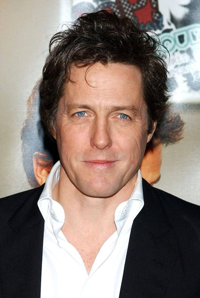 Hugh Grant high resolution event wallpaper stylish black blazer classic charming gaze background