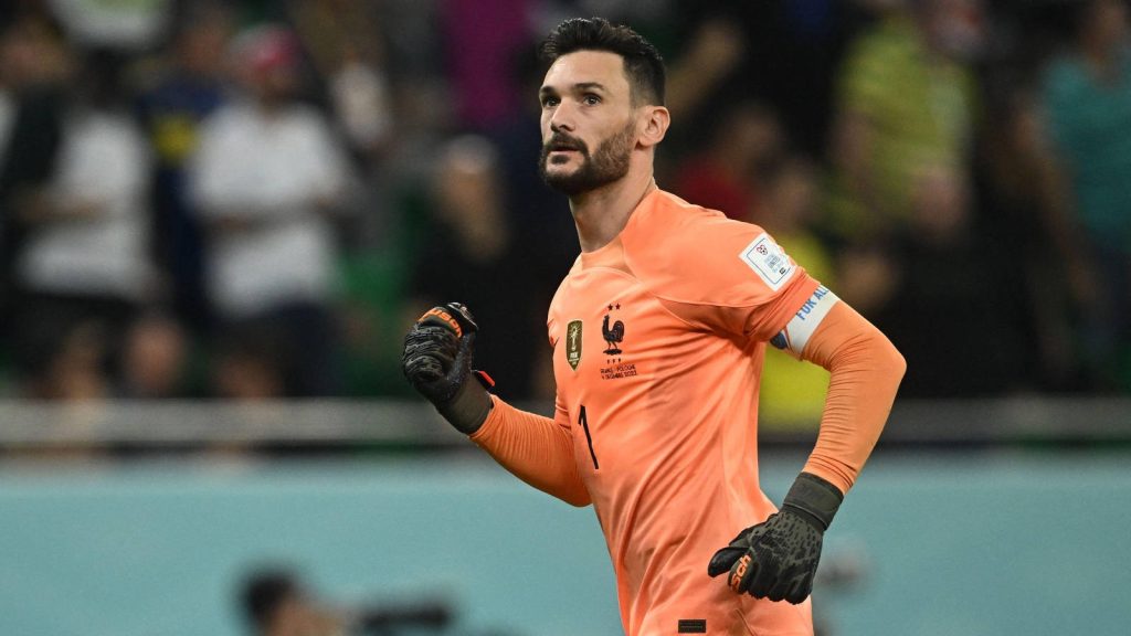 Hugo Lloris in orange kit celebrating World Cup 2022 save vs Poland intense goalkeeper action Wallpaper