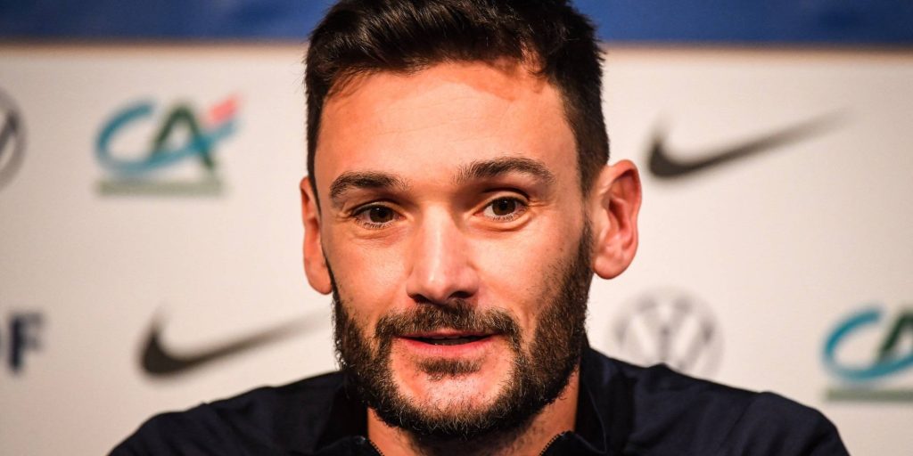 Close-up portrait of French goalkeeper Hugo Lloris at press conference with Nike sponsor logos Wallpaper