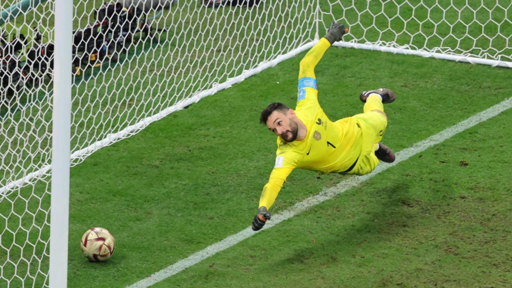 Hugo Lloris diving save in yellow jersey dynamic goalkeeping action sports wallpaper background