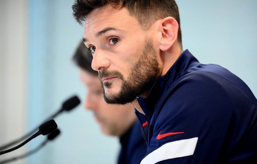 Goalkeeper Hugo Lloris in navy Nike training jacket with focused side glance at press conference Wallpaper