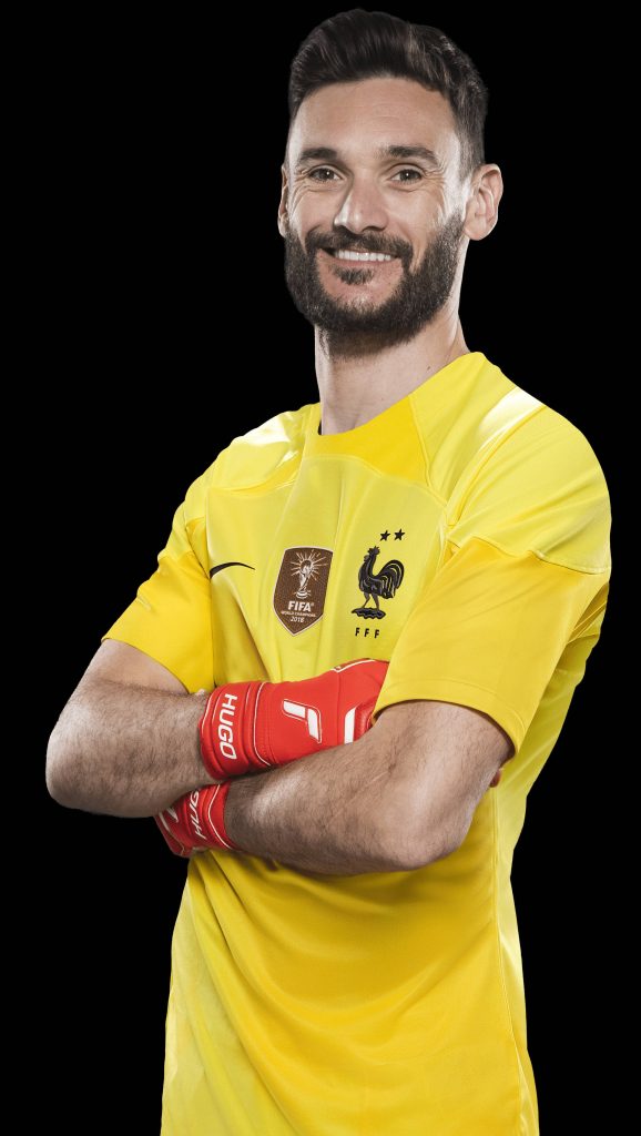 Hugo Lloris in yellow France kit and red gloves posing confidently black background wallpaper